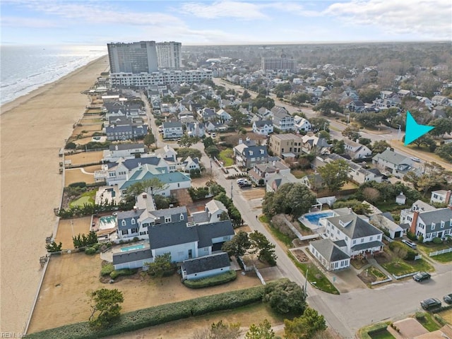 birds eye view of property featuring a water view and a beach view