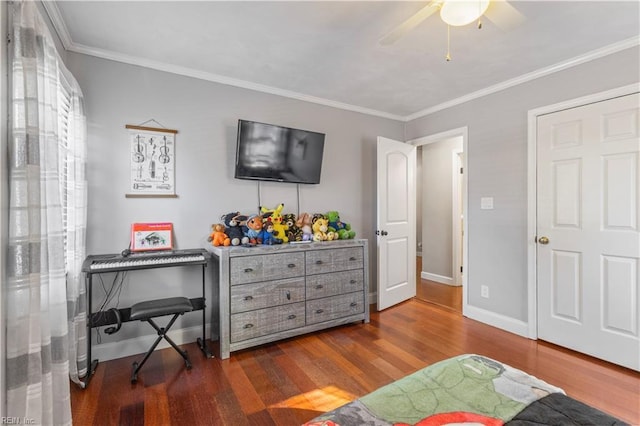 bedroom featuring crown molding, ceiling fan, and dark hardwood / wood-style floors