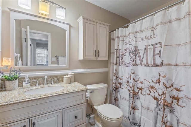 bathroom with vanity, toilet, and walk in shower