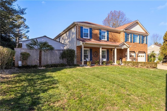 view of front of home with a front yard and a garage