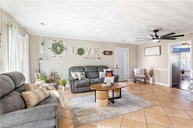 living room featuring ceiling fan and light tile patterned floors