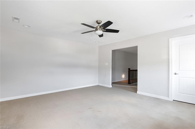 spare room featuring carpet flooring and ceiling fan