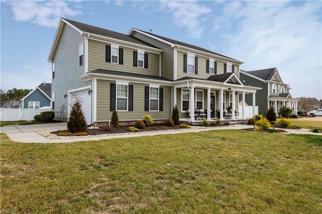 view of front of house featuring covered porch, a garage, and a front yard