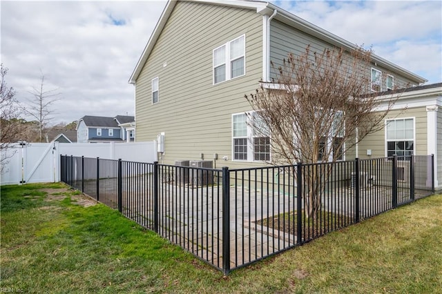 view of home's exterior with a yard and central AC unit