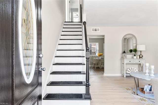 stairway with hardwood / wood-style floors