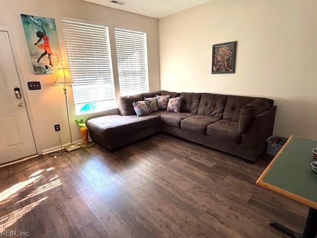 living room with dark hardwood / wood-style flooring