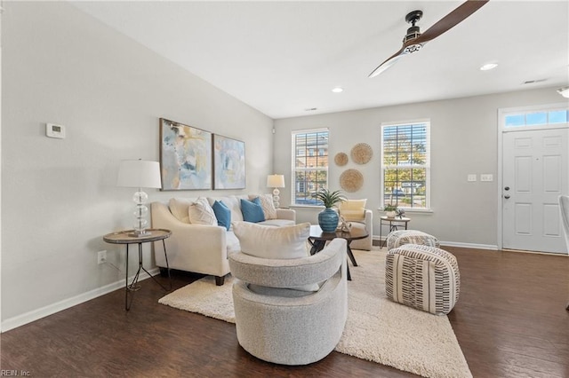 living room with ceiling fan and dark wood-type flooring