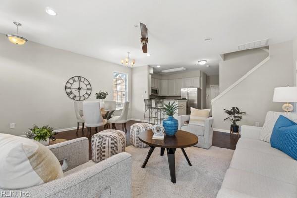 living room with light hardwood / wood-style flooring and an inviting chandelier