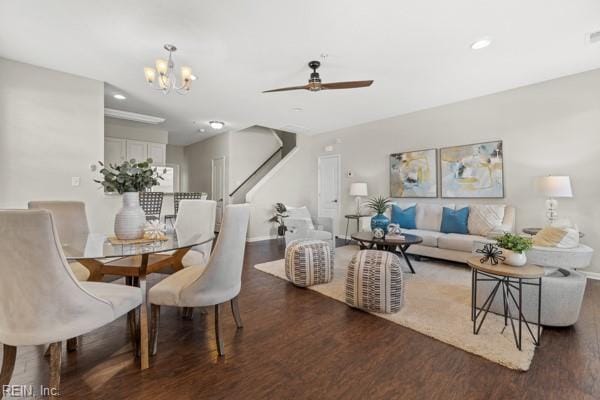 dining room featuring dark hardwood / wood-style flooring and ceiling fan with notable chandelier