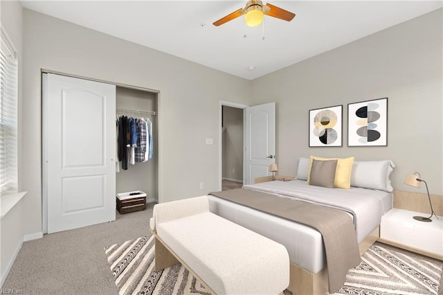 carpeted bedroom with ceiling fan and a closet