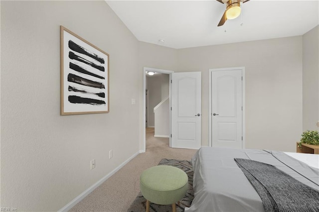 bedroom with ceiling fan and light colored carpet