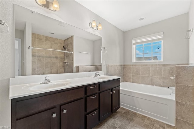 bathroom featuring vanity and separate shower and tub