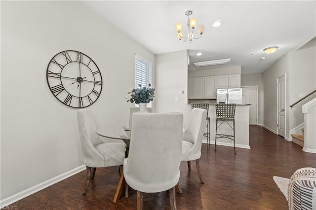 dining space with a chandelier and dark hardwood / wood-style floors