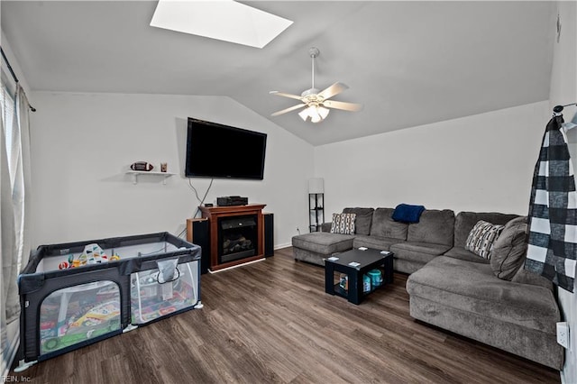 living room with vaulted ceiling with skylight, ceiling fan, and wood-type flooring