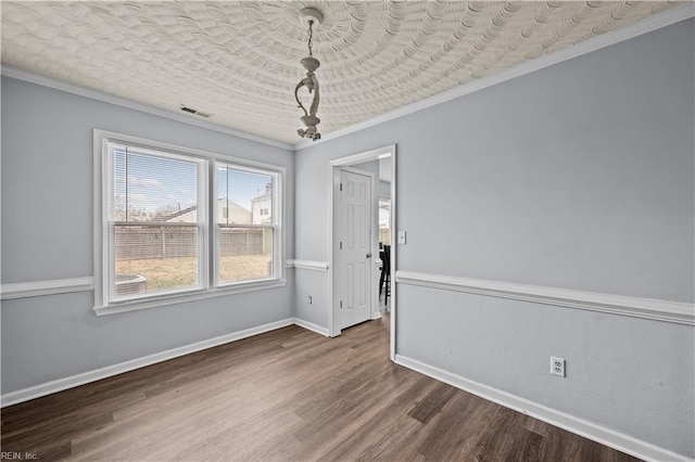 unfurnished dining area with crown molding, hardwood / wood-style floors, and a textured ceiling