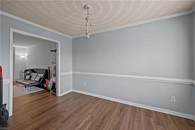 spare room with hardwood / wood-style flooring, ornamental molding, and a textured ceiling