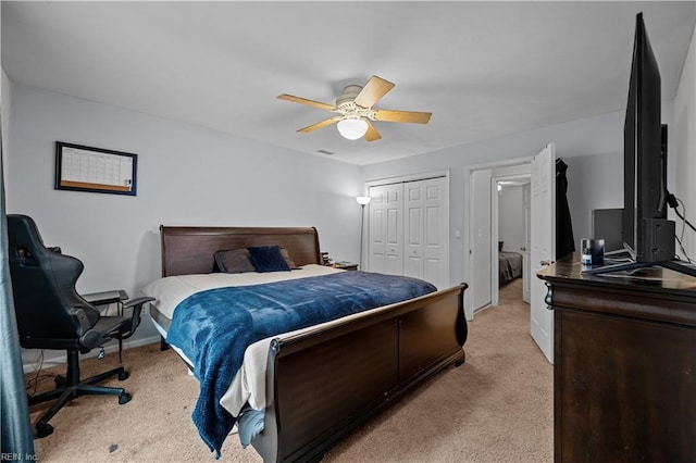 bedroom featuring ceiling fan, light colored carpet, and a closet