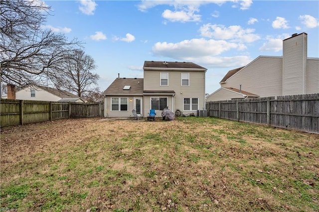 back of property with a lawn and central AC