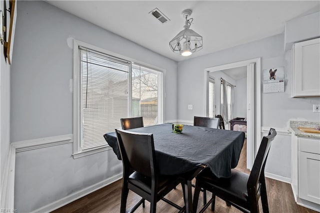 dining room with dark wood-type flooring