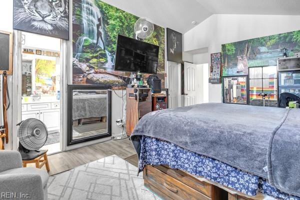 bedroom with wood-type flooring and lofted ceiling