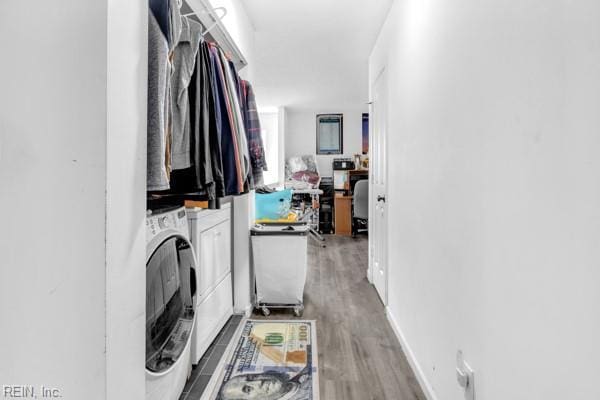 laundry area featuring washer and clothes dryer and hardwood / wood-style flooring