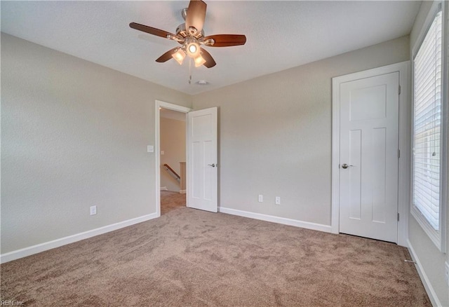 unfurnished bedroom featuring carpet flooring and ceiling fan