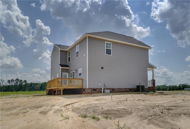 back of property with a wooden deck and central AC unit