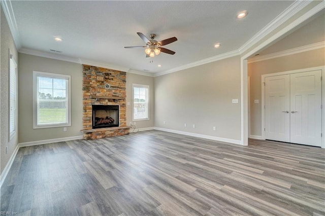 unfurnished living room with crown molding, a fireplace, ceiling fan, and light hardwood / wood-style floors