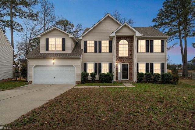 view of front of property featuring a garage and a yard