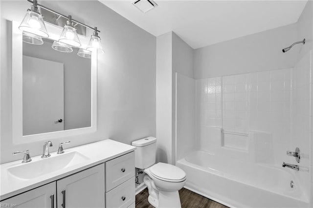 full bathroom with hardwood / wood-style floors, vanity, toilet, and shower / bathtub combination