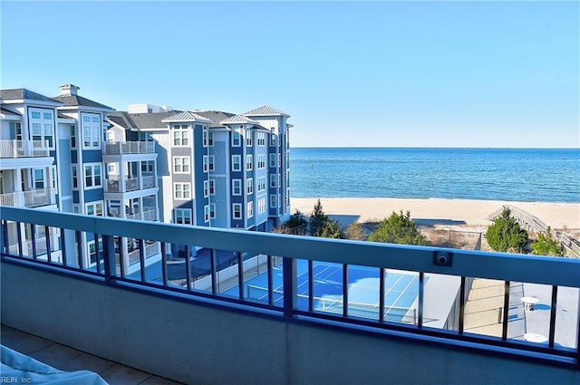 balcony with a water view and a beach view