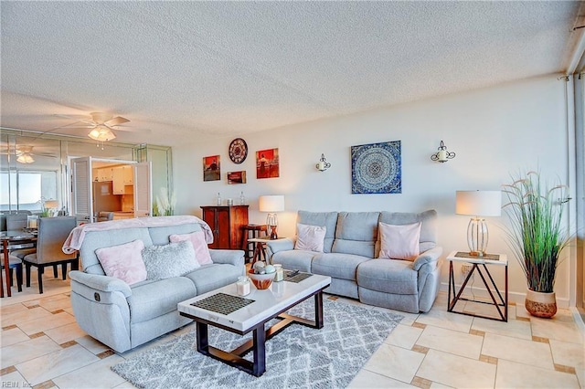 tiled living room featuring ceiling fan and a textured ceiling