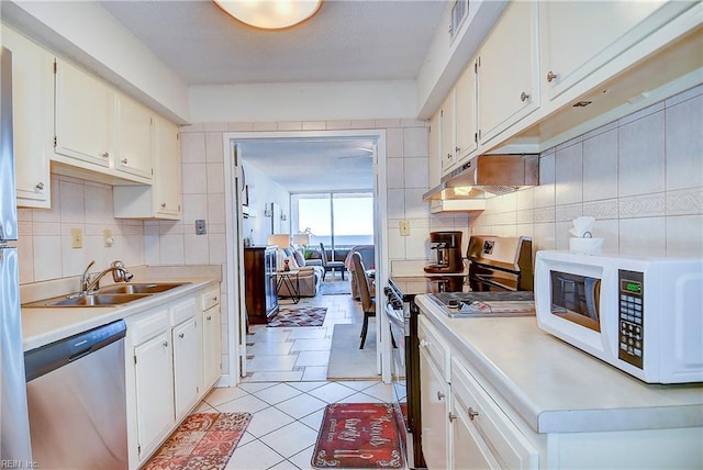 kitchen featuring white cabinets, stainless steel appliances, and sink