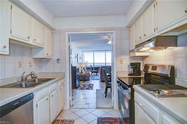 kitchen with white cabinetry, sink, light tile patterned flooring, and stainless steel appliances