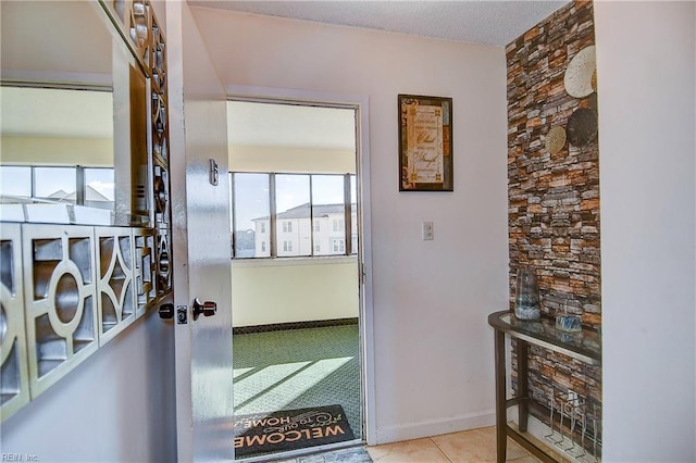 interior space featuring light tile patterned floors and a textured ceiling