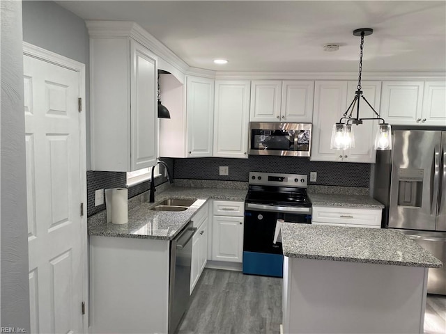 kitchen featuring light stone counters, sink, white cabinets, and appliances with stainless steel finishes