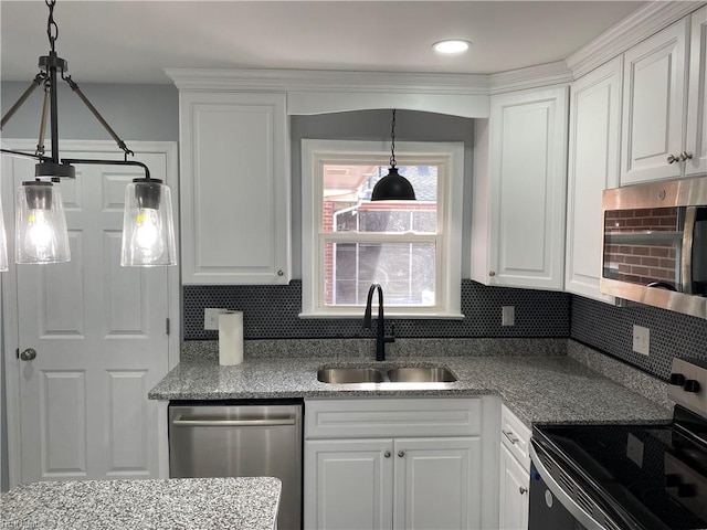 kitchen featuring decorative backsplash, appliances with stainless steel finishes, light stone counters, sink, and white cabinets