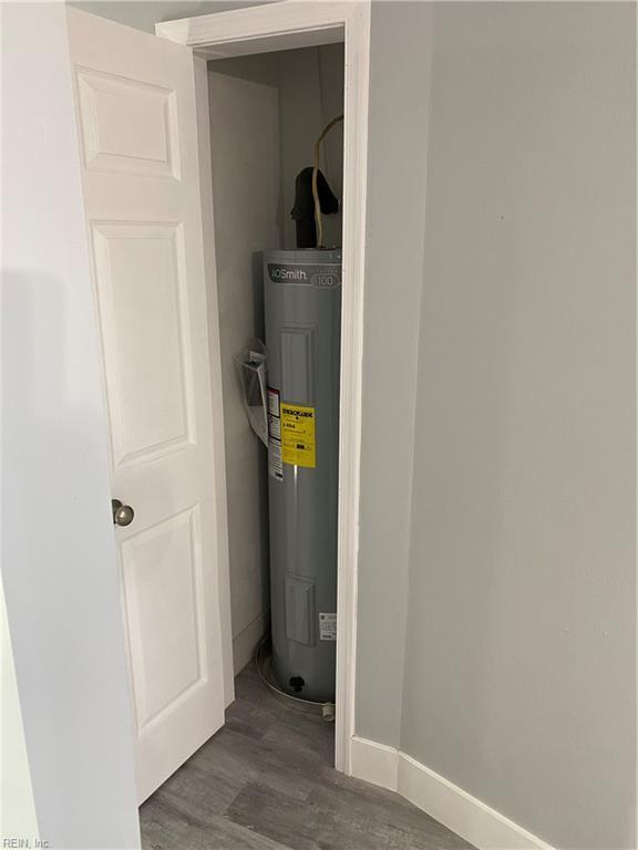 utility room featuring water heater