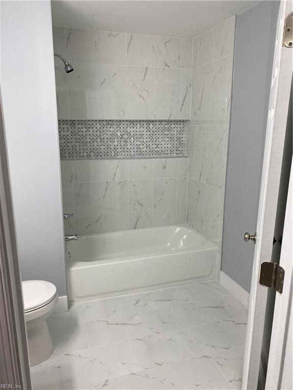 bathroom featuring shower / bathing tub combination and toilet