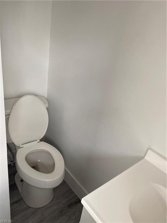 bathroom featuring hardwood / wood-style floors and toilet