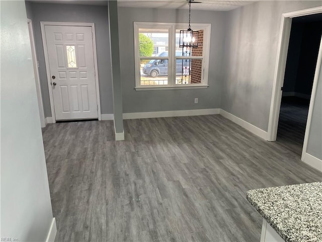 entrance foyer with wood-type flooring and a chandelier