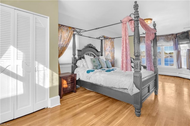 bedroom featuring hardwood / wood-style flooring and a baseboard radiator