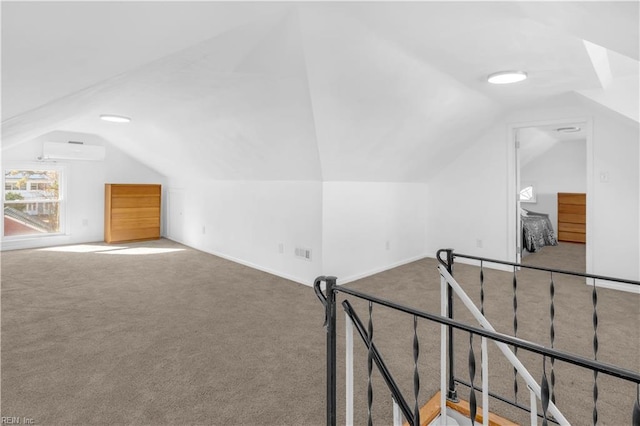 bonus room with a wall mounted air conditioner, carpet floors, and vaulted ceiling