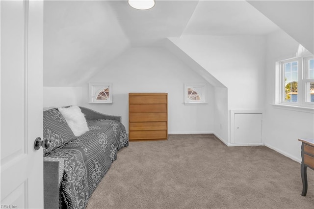 carpeted bedroom featuring lofted ceiling