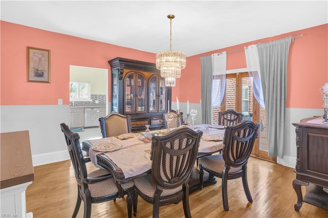 dining area with a chandelier and light hardwood / wood-style flooring