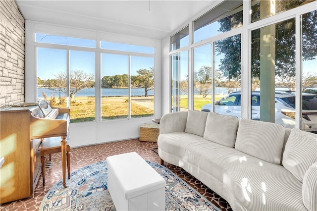 sunroom / solarium featuring a water view and a wealth of natural light