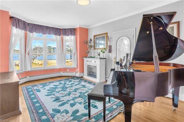 miscellaneous room with light wood-type flooring, a water view, baseboard heating, and crown molding