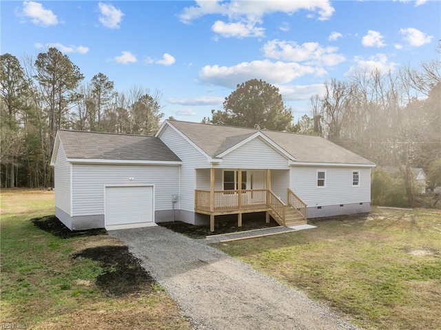 view of front of home with covered porch, a front yard, and a garage