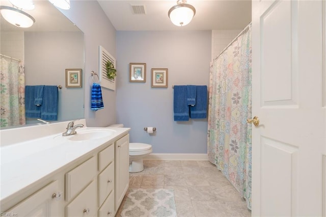 bathroom featuring tile patterned floors, vanity, and toilet