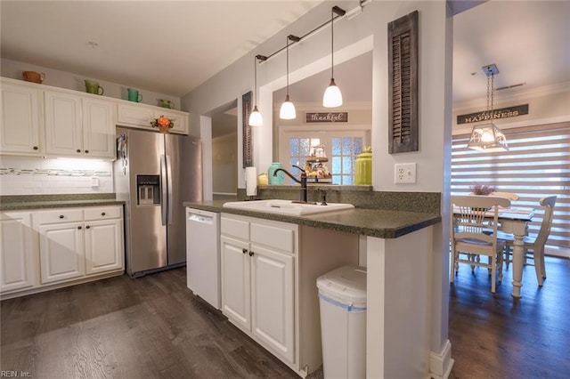 kitchen with kitchen peninsula, stainless steel refrigerator with ice dispenser, white cabinetry, and sink